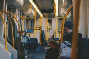 Commuters engaging in reading and relaxing on a modern Portland tram.
